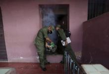 A Cuban military reservist fumigates inside a home in Havana, February 22, 2016. PHOTO BY REUTERS/Enrique de la Osa