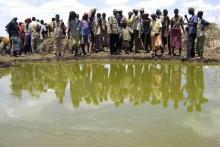 Residents gather to collect water at a contaminated reservoir in a file photo. PHOTO BY REUTERS/Ismail Taxta