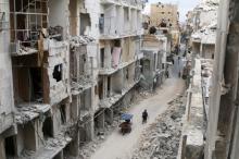 Residents walk near damaged buildings in the rebel held area of Old Aleppo, Syria, May 5, 2016. PHOTO BY REUTERS/Abdalrhman Ismail