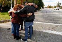 Local residents as they wait to return to their homes near the scene of the investigation of an SUV where two suspects were shot by police following a mass shooting in San Bernardino, California, December 3, 2015. PHOTO BY REUTERS/Mike Blake