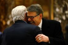 Former Texas Governor Rick Perry is greeted as he exits following a meeting with U.S. President-elect Donald Trump at Trump Tower in Manhattan, New York City, U.S., December 12, 2016. PHOTO BY REUTERS/Brendan McDermid