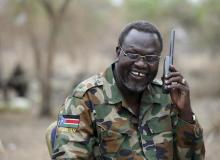 Riek Machar talks on the phone in his field office in a rebel-controlled territory in Jonglei State, South Sudan, February 1, 2014. PHOTO BY REUTERS/Goran Tomasevic