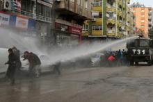 Turkish riot police use a water cannon to disperse Kurdish demonstrators during a protest against a curfew in Sur district and security operations in the region, in the southeastern city of Diyarbakir, Turkey, January 17, 2016. PHOTO BY REUTERS/Sertac Kayar