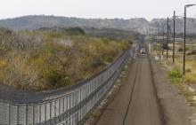 The frontier road parallels the security fence leading to the Northeast gate at Guantanamo Bay U.S. Naval Base, March 8, 2013. PHOTO BY REUTERS/Bob Strong