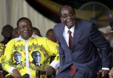 Zimbabwe's President Robert Mugabe (R) shares a joke with his vice-President Emmerson Mnangagwa during Mugabe's birthday celebrations at Great Zimbabwe in Masvingo, February 27, 2016. PHOTO BY REUTERS/Philimon Bulawayo