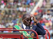 Zimbabwe's President Robert Mugabe gestures from on board a truck as he inspects a guard of honour during the Defence Force's 36th Anniversary celebrations in the capital Harare, Zimbabwe, August 9, 2016. PHOTO BY REUTERS/Philimon Bulawayo
