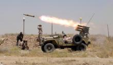 Members of Iraq's Shi'ite paramilitaries launch a rocket towards Islamic State militants in the outskirts of the city of Falluja, in the province of Anbar, Iraq July 12, 2015. PHOTO BY REUTERS/Stringer