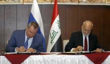 Iraqi Foreign Minister Ibrahim al-Jaafari (R) and Russia's Deputy Prime Minister Dmitry Rogozin (L) sign documents in Baghdad, Iraq, February 11, 2016. PHOTO BY REUTERS/Khalid al Mousily