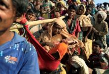 Fsarul Begum, a Rohingya refugee who fled from Myanmar is carried with her new born baby as they wait to be let through after crossing the border in Palang Khali, Bangladesh, October 16, 2017. PHOTO BY REUTERS/Zohra Bensemra