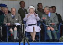 Members of Britain's royal family (front L-R) Prince Philip, Queen Elizabeth and Prince Charles cheer as competitors participate in a sack race at the Braemar Gathering in Braemar, Scotland, September 1, 2012. PHOTO BY REUTERSRussell Cheyne