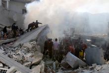 Residents remove debris while looking for survivors amid the rubble of collapsed buildings after what activists said were air strikes by forces loyal to Syria's President Bashar al-Assad in Arbeen, in the eastern Damascus suburb of Ghouta, February 21, 2015. PHOTO BY REUTERS/Yaseen Al-Bushy