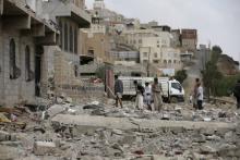 People salvage belongings from the rubble of a house destroyed by a Saudi-led air strike in Yemen's capital Sanaa, September 7, 2015. PHOTO BY REUTERS/Khaled Abdullah