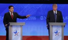 Republican U.S. presidential candidate Senator Marco Rubio (L) speaks as businessman Donald Trump (R) listens during the Republican U.S. presidential candidates debate sponsored by ABC News at Saint Anselm College in Manchester, New Hampshire, February 6, 2016. PHOTO BY REUTERS/Carlo Allegri