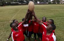 Members of the Kenya Women's Rugby team hold the ball as a team after a light training session at the RFUEA grounds in the capital Nairobi, April 4, 2016. PHOTO BY REUTERS/Thomas Mukoya