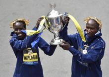 Boston Marathon women's division winner Edna Kiplagat, of Kenya, and men's division winner Geoffrey Kirui, also of Kenya, hold the trophy during the 121st Boston Marathon in Boston, Massachusetts, U.S., April 17, 2017. PHOTO BY REUTERS/Gretchen Ertl