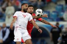 Tunisia's Saber Khalifa in action with England's Kyle. PHOTO BY REUTERS/Ueslei Marcelino
