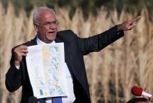 Palestinian Chief negotiator Saeb Erekat holds a map as he speaks to media about the Israeli plan to appropriate land, in Jordan Valley near the West Bank city of Jericho, January 20, 2016. PHOTO BY REUTERS/Mohamad Torokman