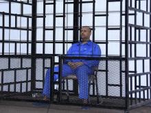 Saif al-Islam Gaddafi, son of late Libyan leader Muammar Gaddafi, attends a hearing behind bars in a courtroom in Zintan, May 25, 2014. PHOTO BY REUTERS/Stringer