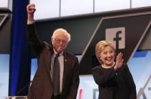 Democratic U.S. presidential candidates Senator Bernie Sanders and Hillary Clinton wave before the start of the Univision News and Washington Post Democratic U.S. presidential candidates debate in Kendall, Florida, March 9, 2016. PHOTO BY REUTERS/Javier Galeano
