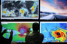 Members of the Emergency Operations Committee (COE) photograph the trajectory of Hurricane Maria in Santo Domingo, Dominican Republic, September 19, 2017. PHOTO BY REUTERS/Ricardo Rojas