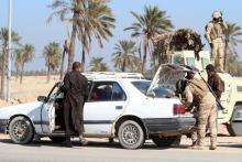 Iraqi soldiers search vehicles on the outskirts of Basra, January 14, 2016. PHOTO BY REUTERS/Essam Al-Sudani