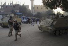 Security forces take their positions during clashes with gunmen in Kerdasa, a town 14 km (9 miles) from Cairo