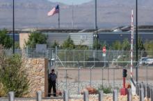 A security officer keeps watch over a tent encampment housing immigrant children just north of the Mexican border in Tornillo, Texas, U.S., June 20, 2018. PHOTO BY REUTERS/Mike Blake