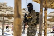 A member of Tunisia's special forces inspects the beachside of the Imperial Marhaba resort, while British, French, German and Tunisia's interior ministers arrive to pay their tribute in front of a makeshift memorial in Sousse, Tunisia, June 29, 2015. PHOTO BY REUTERS/Zohra Bensemra