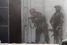 Afghan security forces take position at the scene of an attack on the Indian consulate in Herat province