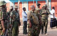 Kenya Defence Forces soldiers and policemen gather at the scene of an overnight attack on a residential complex in Soko Mbuzi village of Mandera town at the Kenya-Somalia border, July 7, 2015. PHOTO BY REUTERS/Stringer