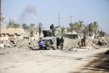 Iraqi security forces gather during a patrol in the city of Ramadi, January 16, 2016. PHOTO BY REUTERS/Thaier Al-Sudani