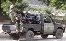 Somalia security forces transport blind-folded suspects detained on their pick-up truck after attackers from the militant group al Shabaab invaded the African Union's Halane base on the edge of the Mogadishu international airport compound in Somalia's capital Mogadishu, December 26, 2014. PHOTO BY REUTERS/Feisal Omar