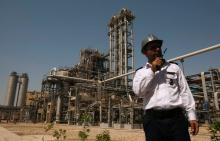 A security personnel stands in front of the Mahshahr petrochemical plant in Khuzestan province,1032 km (641 miles) southwest of Tehran, September 28, 2011. PHOTO BY REUTERS/Raheb Homavandi