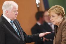 Bavarian Prime Minister and head of the Christian Social Union (CSU) Horst Seehofer talks with German Chancellor Angela Merkel prior to a meeting of German state leaders to discuss the migrant crisis, in Berlin, Germany, December 3, 2015. PHOTO BY REUTERS/Hannibal Hanschke