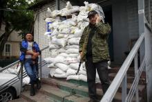 Members of a group of separatists stand outside an office in the town of Druzhkovka, Donetsk region