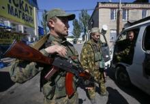 Pro-Russian separatists talk as they guard the area at a check point on the outskirts of Donetsk, September 6, 2014. PHOTO BY REUTERS/Maxim Shemetov