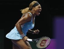Serena Williams of the U.S. shouts as she wins a point against Caroline Wozniacki of Denmark during their WTA Finals singles semi-finals tennis match at the Singapore Indoor Stadium, October 25, 2014. PHOTO BY REUTERS/Edgar Su