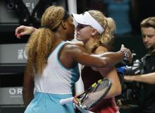 Serena Williams of the U.S. is congratulated by Caroline Wozniacki of Denmark during their WTA Finals singles semi-final tennis match at the Singapore Indoor Stadium, October 25, 2014. PHOTO BY REUTERS/Edgar Su
