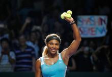 Serena Williams of the U.S. celebrates her win over Caroline Wozniacki of Denmark during their WTA Finals singles semi-finals tennis match at the Singapore Indoor Stadium, October 25, 2014. PHOTO BY REUTERS/Edgar Su