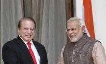 India's Prime Minister Narendra Modi (R) and his Pakistani counterpart Nawaz Sharif smile in New Delhi, May 27, 2014. PHOTO BY REUTERS/Adnan Abidi