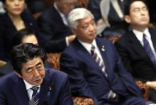 Japan's Prime Minister Shinzo Abe (L) speaks next to Defence Minister Gen Nakatani (C) and Foreign Minister Fumio Kishida (R) during an upper house committee session at the parliament in Tokyo, February 2, 2015. PHOTO BY REUTERS/Yuya Shino