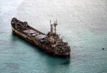 Filipino soldiers wave from the dilapidated Sierra Madre ship of the Philippine Navy as it is anchored near Ayungin shoal (Second Thomas Shoal) in the Spratly group of islands in the South China Sea, west of Palawan, Philippines, May 11, 2015. PHOTO BY REUTERS/Ritchie A. Tongo