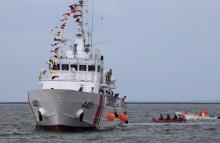 Security personnel onboard rubber boats assist in the docking procedures of BRP Tubbataha, one of 10 multi-role vessel the Philippines is acquiring from Japan under a 8.8 billion pesos (US$ 190million) agreement, as it arrives in south harbor, metro Manila, Philippines August 18, 2016. PHOTO BY REUTERS/Romeo Ranoco