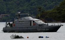 A Navy ship is seen near the wreckage from a plane, which crashed with Brazilian Supreme Court Justice Teori Zavascki, who was overseeing a graft investigation into scores of powerful politicians, in Paraty, Rio de Janeiro state, Brazil, January 20, 2017. PHOTO BY REUTERS/Bruno Kelly