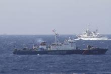 A ship (top) of Chinese Coast Guard is seen near a ship of Vietnam Marine Guard in the South China Sea, about 210 km (130 miles) off shore of Vietnam, May 14, 2014. PHOTO BY REUTERS/Nguyen Minh