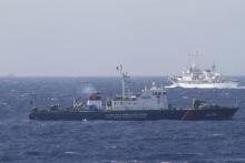 A ship (top) of Chinese Coast Guard is seen near a ship of Vietnam Marine Guard in the South China Sea, about 210 km (130 miles) off shore of Vietnam, May 14, 2014. PHOTO BY REUTERS/Nguyen Minh