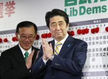 Japan's Prime Minister Shinzo Abe, who is also leader of the ruling Liberal Democratic Party (LDP), claps during an election night event at the LDP headquarters in Tokyo, December 14, 2014. PHOTO BY REUTERS/Toru Hanai