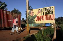A man walks near a sign with an image of Cuban President Raul Castro in Havana, December 19, 2014. PHOTO BY REUTERS/Stringer