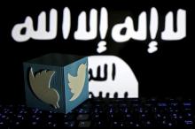A 3D-printed Twitter logo is seen on a keyboard in front of a computer screen on which an Islamic State flag is displayed, in this picture illustration taken in Zenica, Bosnia and Herzegovina, February 6, 2016. PHOTO BY REUTERS/Dado Ruvic