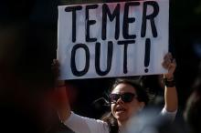 A woman demonstrates against Brazil's president Michel Temer during a protest in Union Square in the Manhattan borough of New York City, New York, U.S., May 21, 2017. PHOTO BY REUTERS/Carlo Allegri